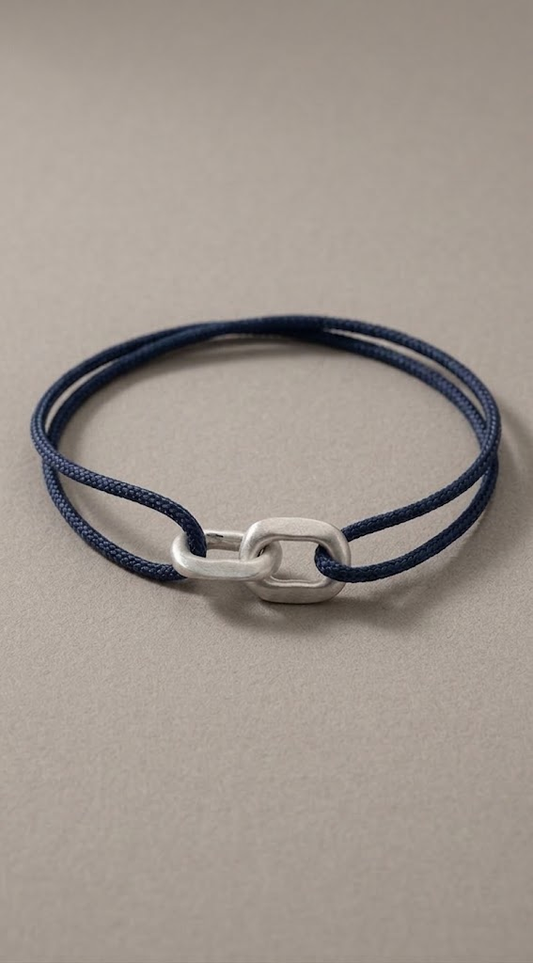 Link Bracelet in 925 silver on a navy woven cord, laid flat