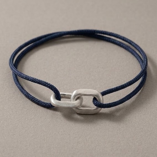 Link Bracelet in 925 silver on a navy woven cord, laid flat