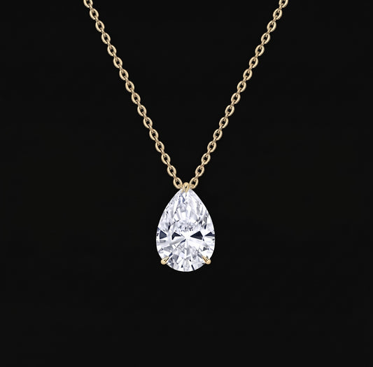Lyra Necklace: pear-cut lab-grown diamond solitaire pendant on a yellow gold chain, black background