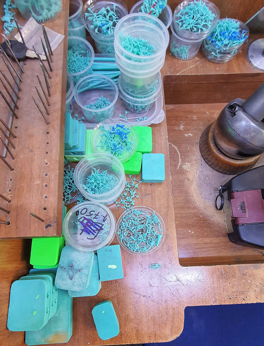 Trays of stones and settings sorted at the bench