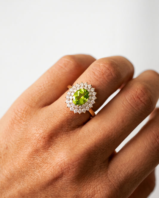 Alina Engagement Ring worn on hand – peridot and diamond double halo ring in 14k gold by Nayiri Jewelry