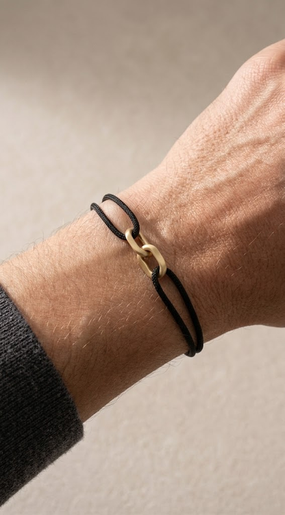Link Bracelet in 14-karat solid gold on a black cord, worn on the wrist