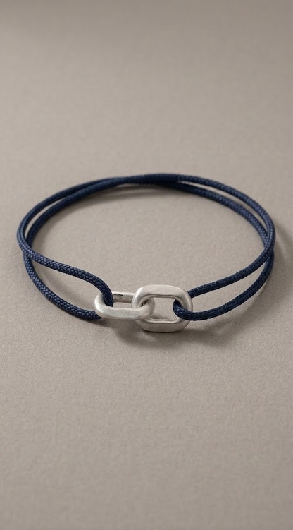 Link Bracelet in 925 silver on a navy woven cord, laid flat