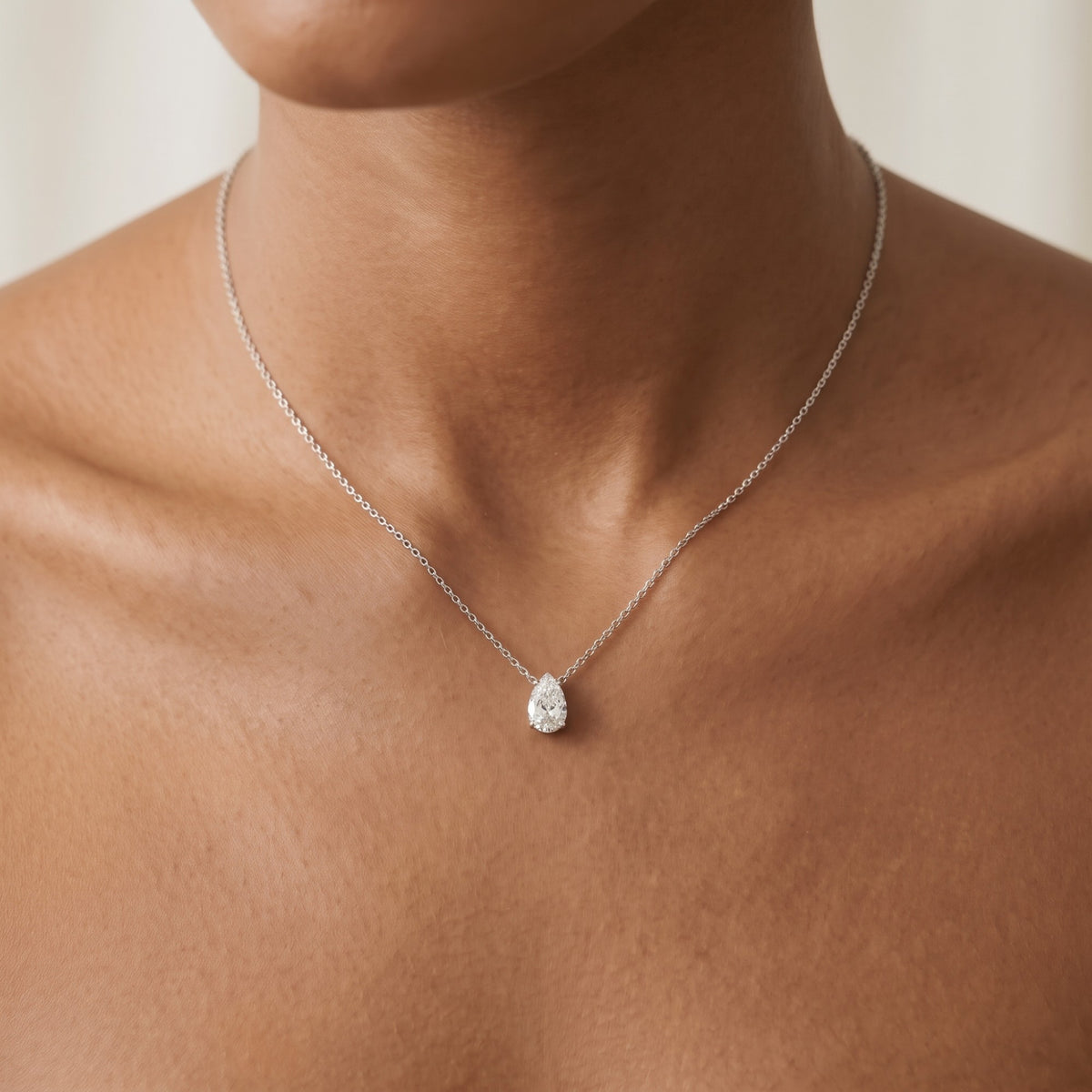 Lyra Necklace: 1 carat pear-cut lab-grown diamond pendant in white gold, worn on the neck