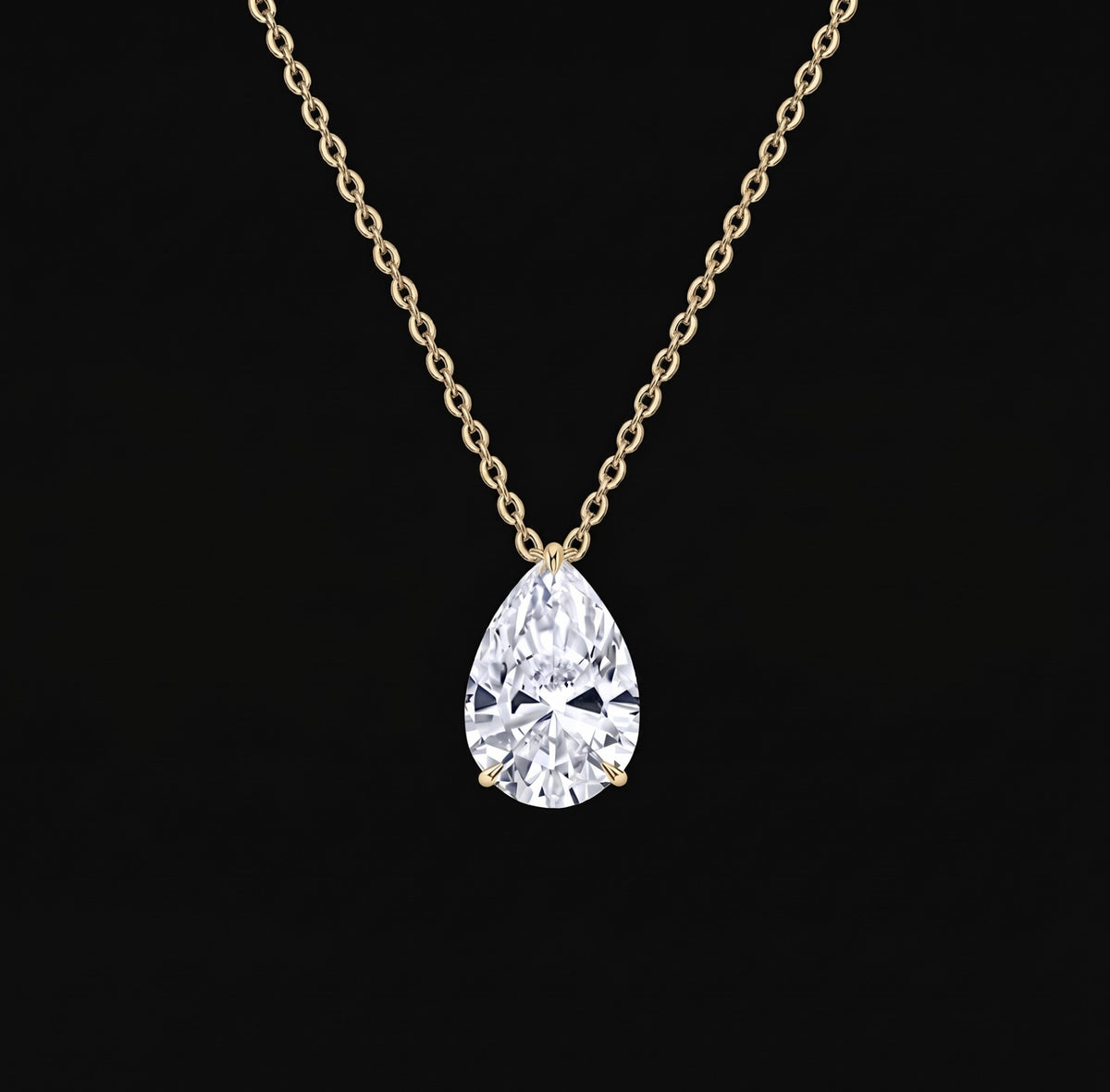 Lyra Necklace: pear-cut lab-grown diamond solitaire pendant on a yellow gold chain, black background