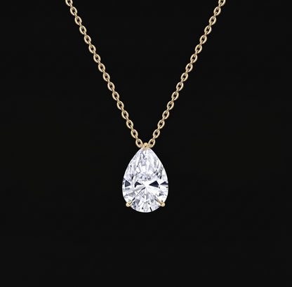 Lyra Necklace: pear-cut lab-grown diamond solitaire pendant on a yellow gold chain, black background
