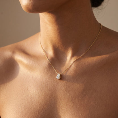 Lyra Necklace: 1 carat pear-cut lab-grown diamond pendant in yellow gold, worn on the neck