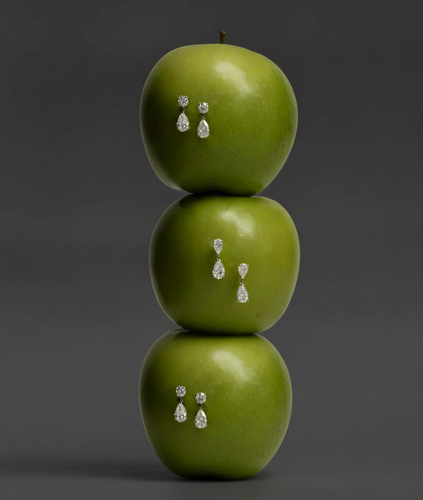 Pear drop earrings on green apples