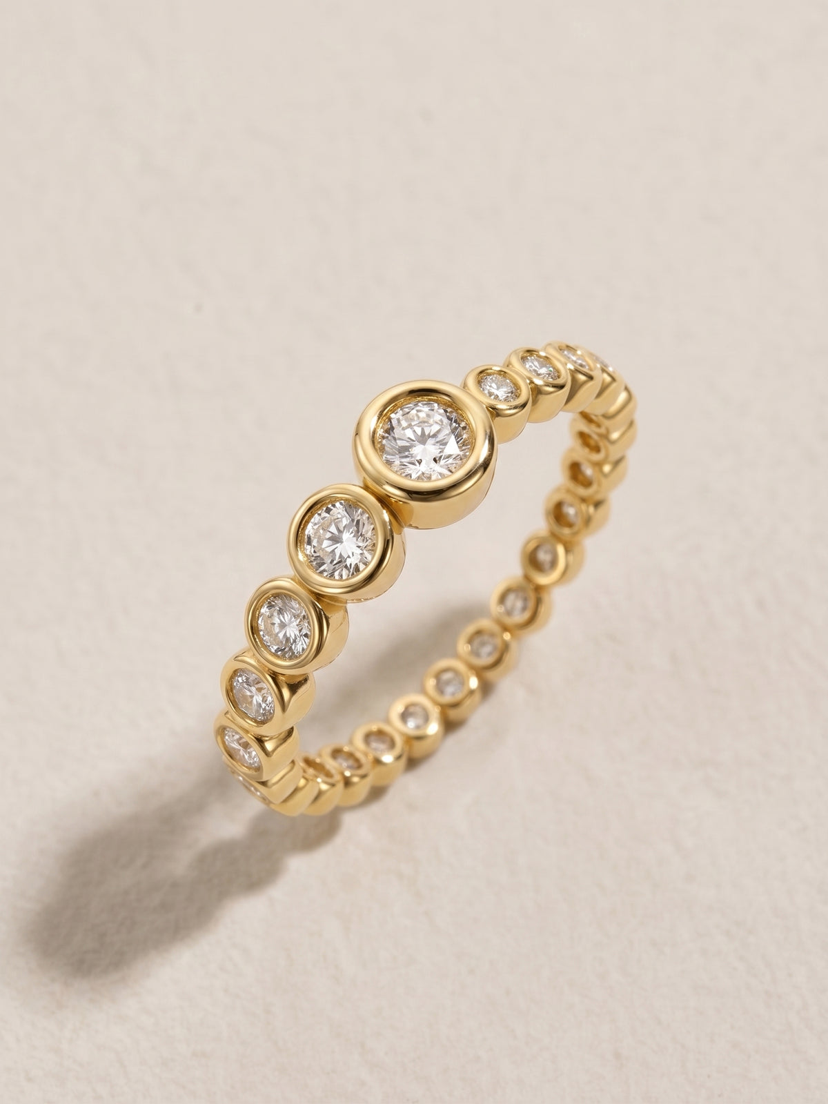 Vega Ring in 14-karat solid yellow gold — graduated bezel-set eternity band with diamonds