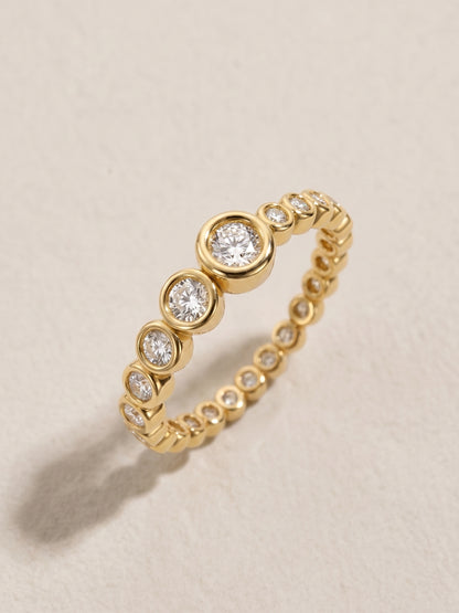 Vega Ring in 14-karat solid yellow gold — graduated bezel-set eternity band with diamonds